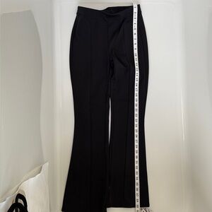 Alo Yoga Black Flared Stretch Pants with inseam zipper at hem